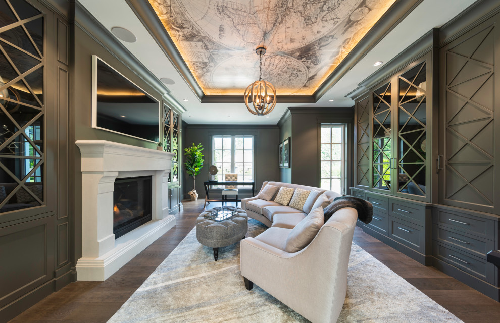 This is an example of a large transitional study room in Vancouver with grey walls, dark hardwood floors, a standard fireplace, a plaster fireplace surround, a freestanding desk, brown floor and coffered.