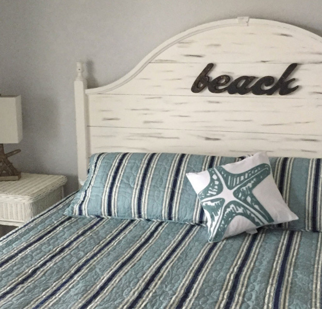 Inspiration for a mid-sized beach style guest bedroom in Other with blue walls and linoleum floors.
