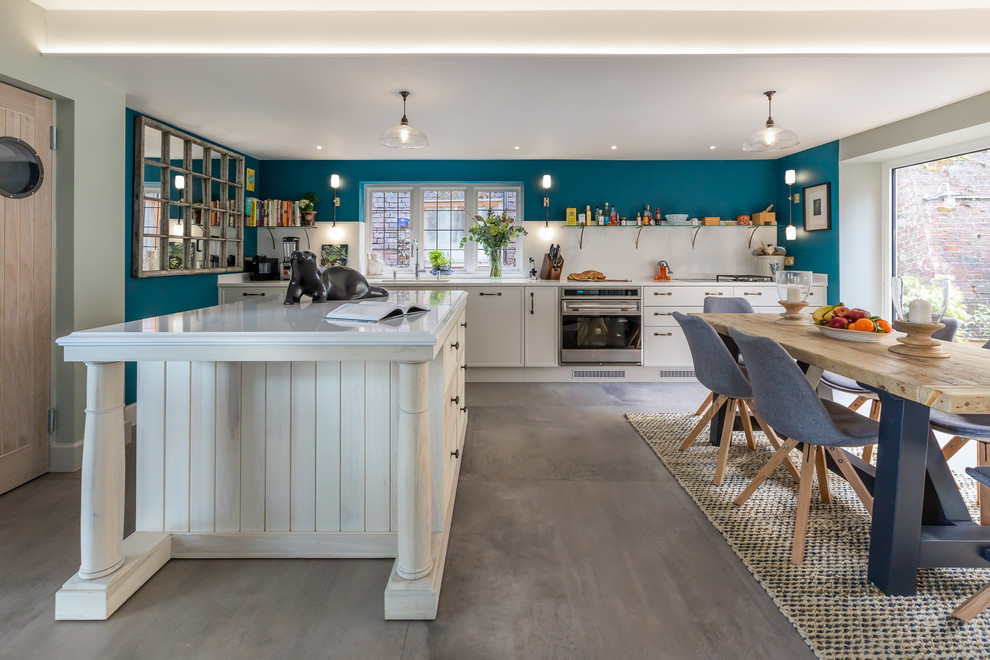 This is an example of a traditional kitchen in Buckinghamshire with a drop-in sink, shaker cabinets, grey cabinets, quartzite benchtops, white splashback, stainless steel appliances, ceramic floors, with island, grey floor and white benchtop.