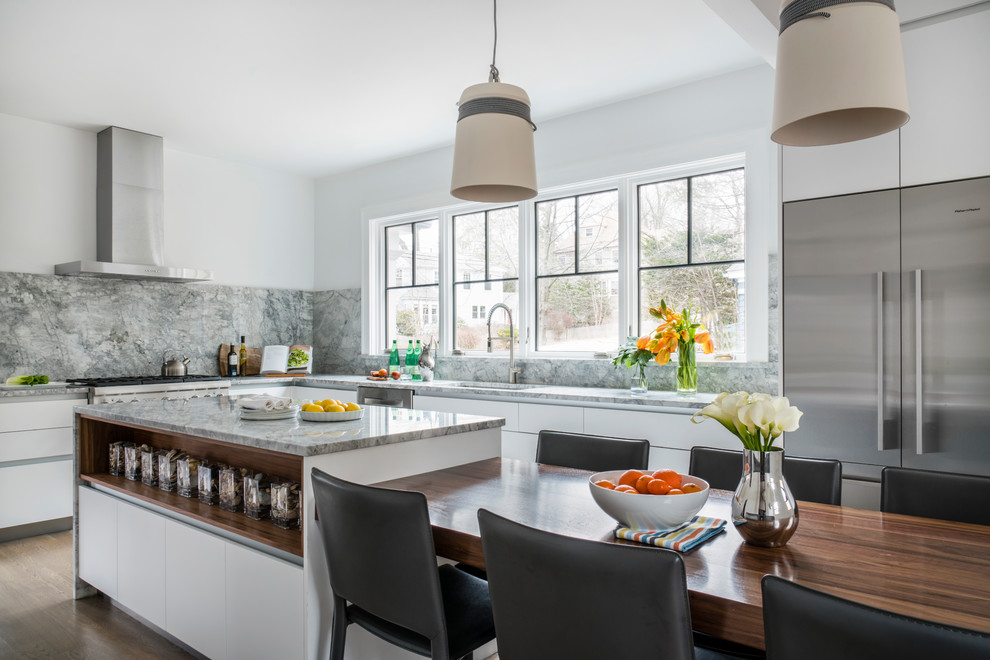 Inspiration for a mid-sized contemporary l-shaped eat-in kitchen in Boston with an undermount sink, flat-panel cabinets, white cabinets, granite benchtops, grey splashback, stone slab splashback, stainless steel appliances, dark hardwood floors, with island, grey floor and grey benchtop.