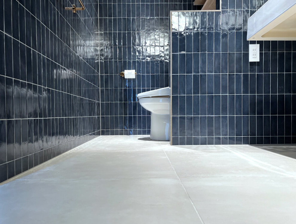 Moderne Gästetoilette mit weißen Schränken, Toilette mit Aufsatzspülkasten, blauen Fliesen, Porzellanfliesen, weißem Boden, weißer Waschtischplatte und schwebendem Waschtisch in Yokohama
