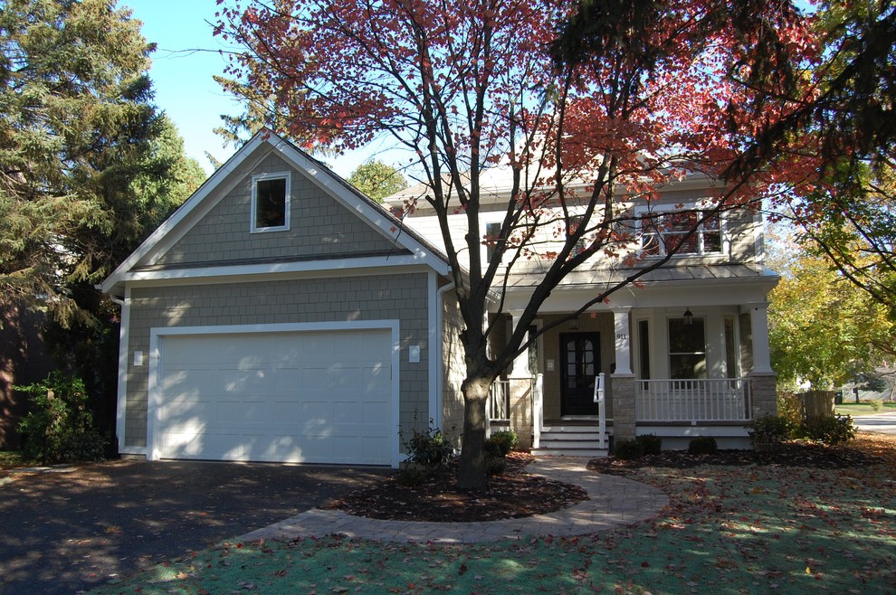 Photo of a mid-sized transitional two-storey beige house exterior in Chicago with wood siding, a gable roof and a shingle roof.