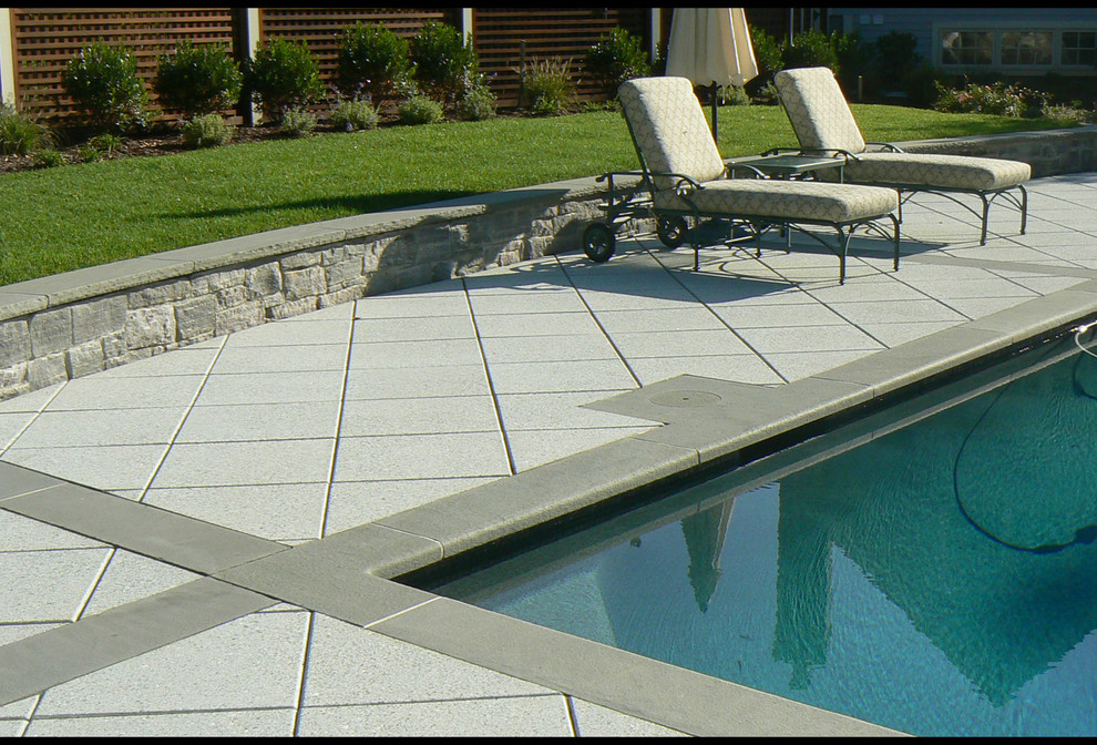 Inspiration for a mid-sized traditional backyard patio in Boston with concrete pavers.