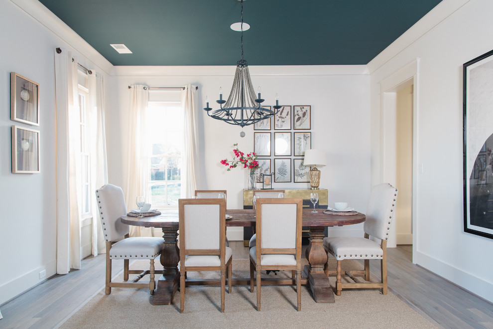 Inspiration for a country separate dining room in Birmingham with white walls, dark hardwood floors and brown floor.