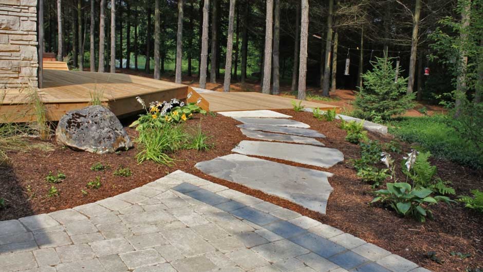 Example of a large mountain style backyard deck design in Toronto with no cover