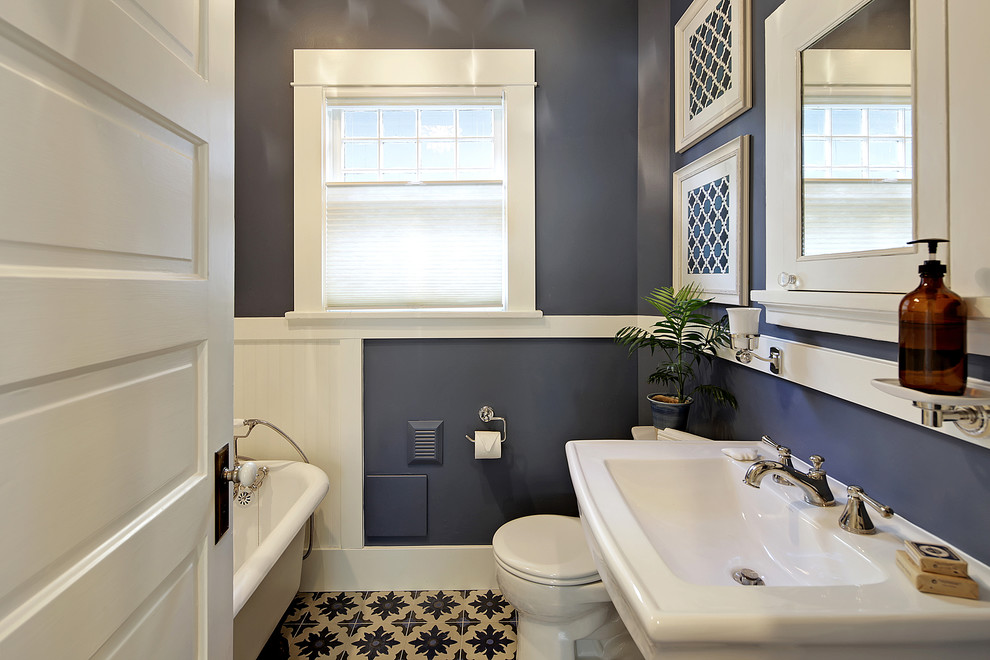 This is an example of a mid-sized traditional 3/4 bathroom in Seattle with a claw-foot tub, a two-piece toilet, blue walls, cement tiles, a pedestal sink and blue floor.