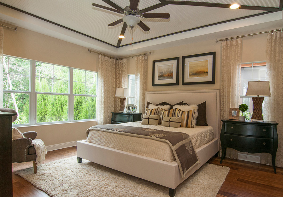 Transitional bedroom in Tampa with light hardwood floors and beige floor.