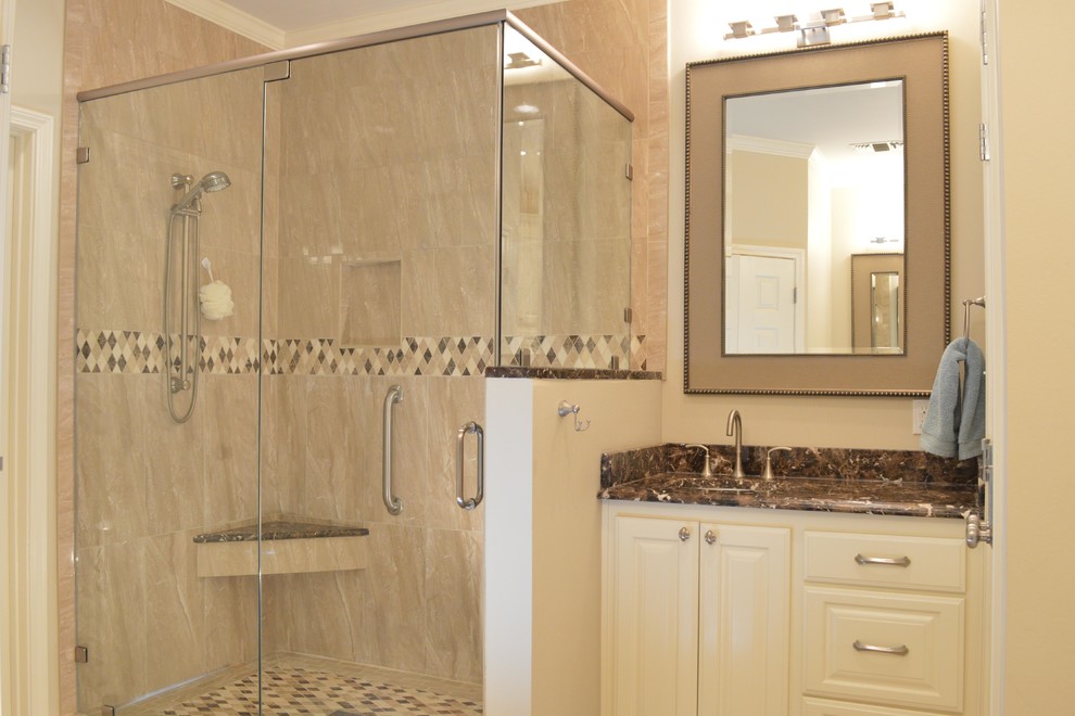 Inspiration for a traditional master bathroom in New Orleans with an undermount sink, white cabinets, marble benchtops, a corner shower, beige tile, stone tile and beige walls.