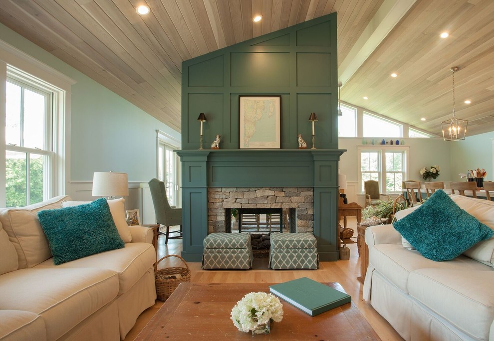 Design ideas for a beach style formal open concept living room in Providence with green walls, light hardwood floors, a two-sided fireplace, a stone fireplace surround and beige floor.