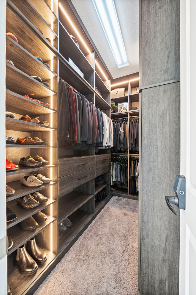 Design ideas for a large modern gender-neutral walk-in wardrobe in Houston with grey cabinets, carpet, grey floor and vaulted.