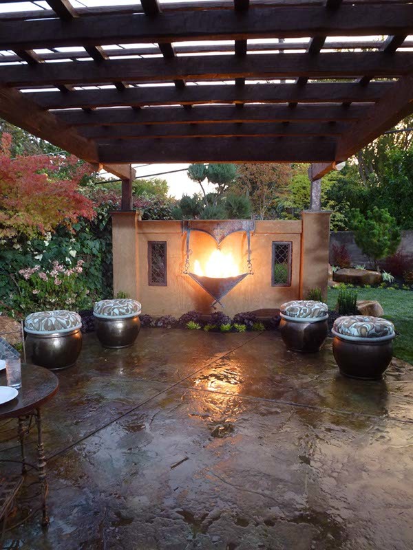 Mid-sized eclectic backyard patio in Sacramento with a fire feature, natural stone pavers and a pergola.