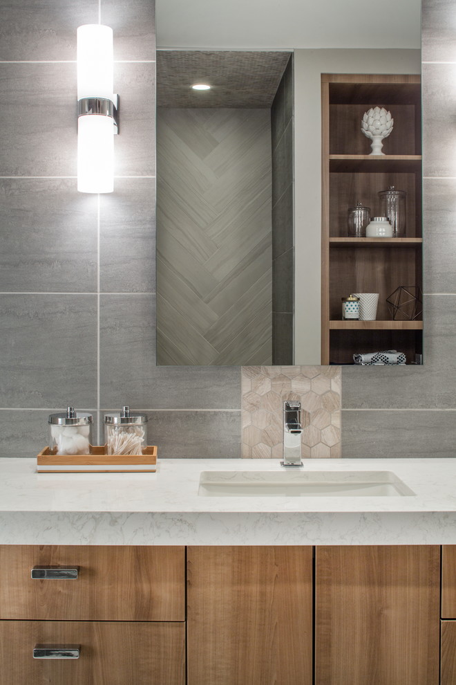 Mid-sized contemporary master bathroom in Omaha with flat-panel cabinets, medium wood cabinets, a curbless shower, a one-piece toilet, white tile, porcelain tile, grey walls, porcelain floors, an undermount sink and engineered quartz benchtops.