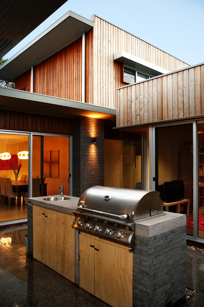 Inspiration for a large contemporary two-storey exterior in Canberra - Queanbeyan with wood siding and a flat roof.