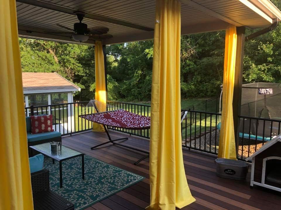 Photo of a mid-sized transitional backyard deck in St Louis with a pergola.
