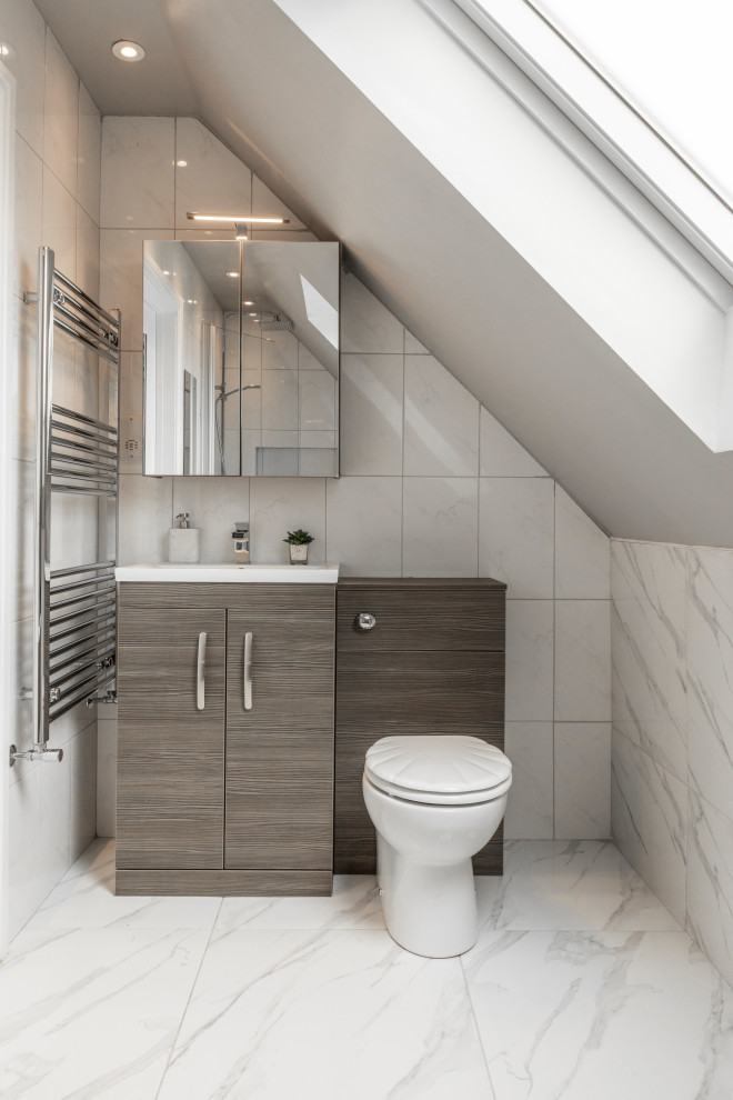 Small contemporary 3/4 bathroom in Essex with flat-panel cabinets, medium wood cabinets, a two-piece toilet, gray tile, porcelain tile, grey walls, porcelain floors, grey floor, white benchtops, a single vanity and a built-in vanity.