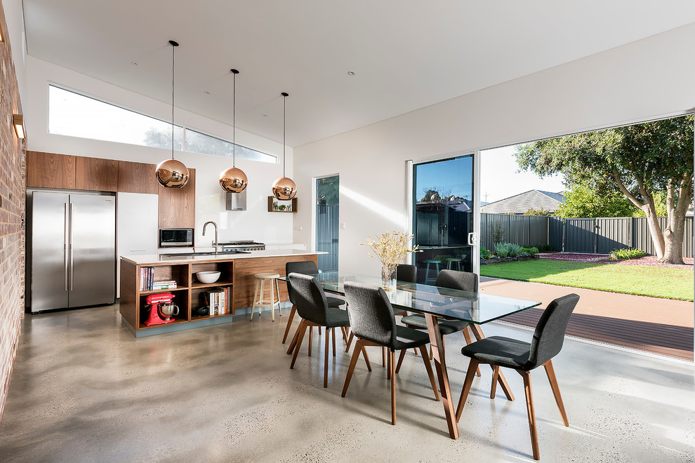 This is an example of a small contemporary dining room in Perth with white walls and concrete floors.