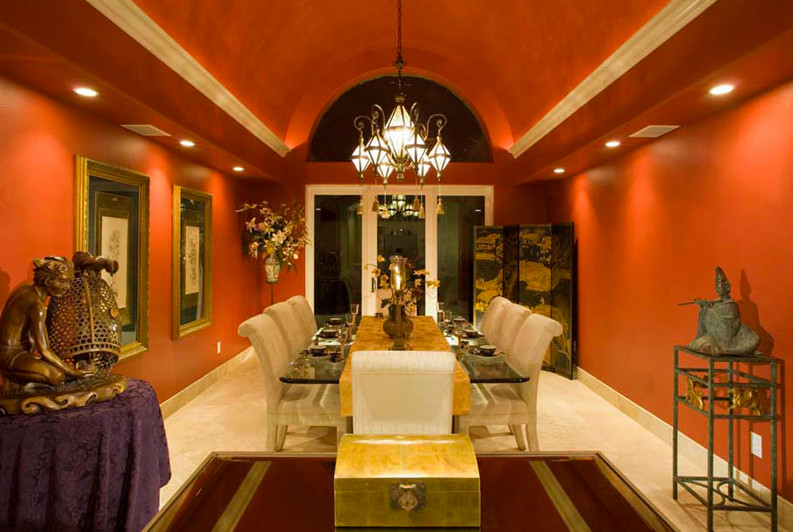 Inspiration for a large asian separate dining room in Orange County with red walls, no fireplace and limestone floors.