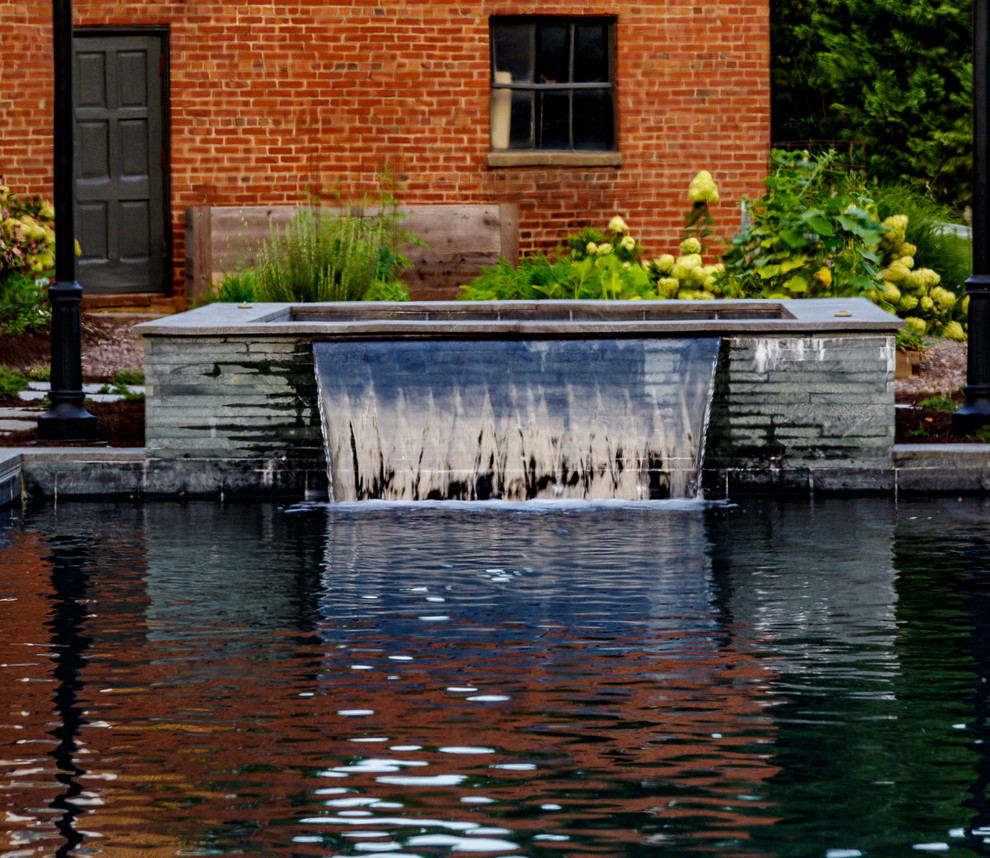 Backyard stone and rectangular hot tub photo
