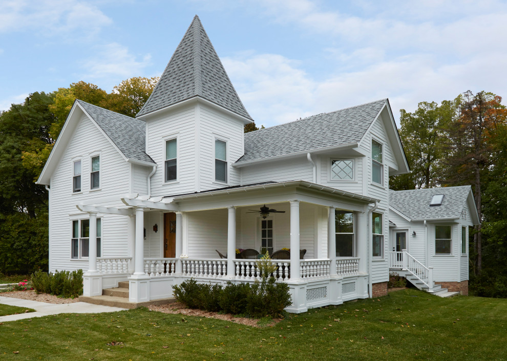 Photo of a traditional two-storey white house exterior in Chicago with a gable roof, a shingle roof, a grey roof and clapboard siding.