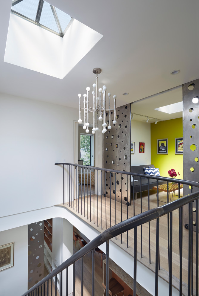 Trendy light wood floor hallway photo in New York with white walls