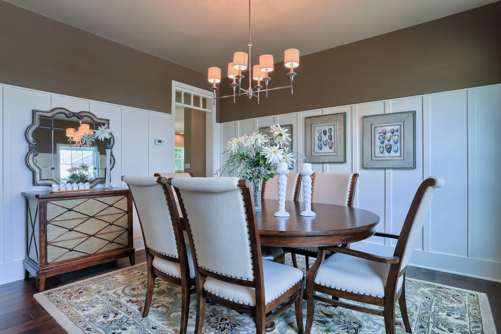 Inspiration for a mid-sized traditional separate dining room in Other with brown walls and dark hardwood floors.