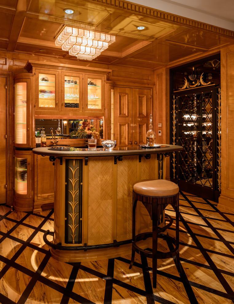 This is an example of a large traditional single-wall wet bar in Milwaukee with glass-front cabinets, medium wood cabinets, granite benchtops, mirror splashback, light hardwood floors and multi-coloured floor.