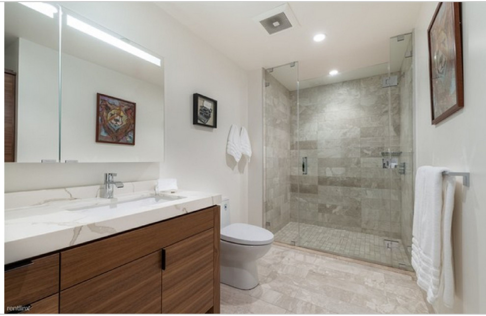 Design ideas for a mid-sized contemporary 3/4 bathroom in Sacramento with flat-panel cabinets, medium wood cabinets, a curbless shower, a two-piece toilet, beige tile, ceramic tile, white walls, laminate floors, an undermount sink, granite benchtops, beige floor, a hinged shower door, white benchtops, a freestanding vanity and a double vanity.