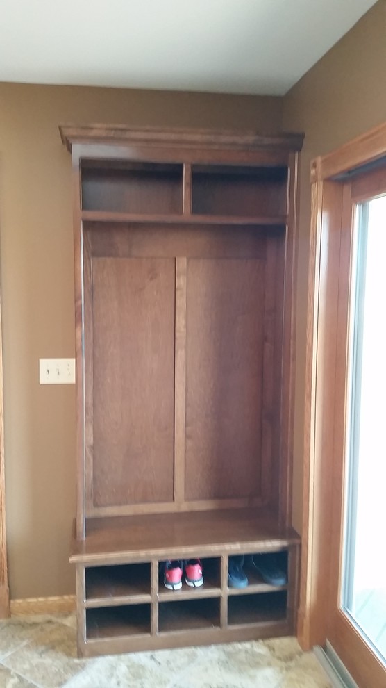 Example of a classic ceramic tile mudroom design