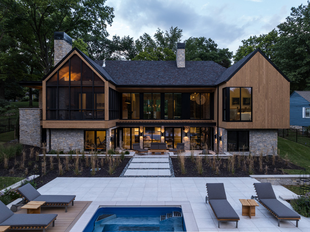 Inspiration for a large contemporary brown wood exterior home remodel in Kansas City with a shingle roof and a gray roof