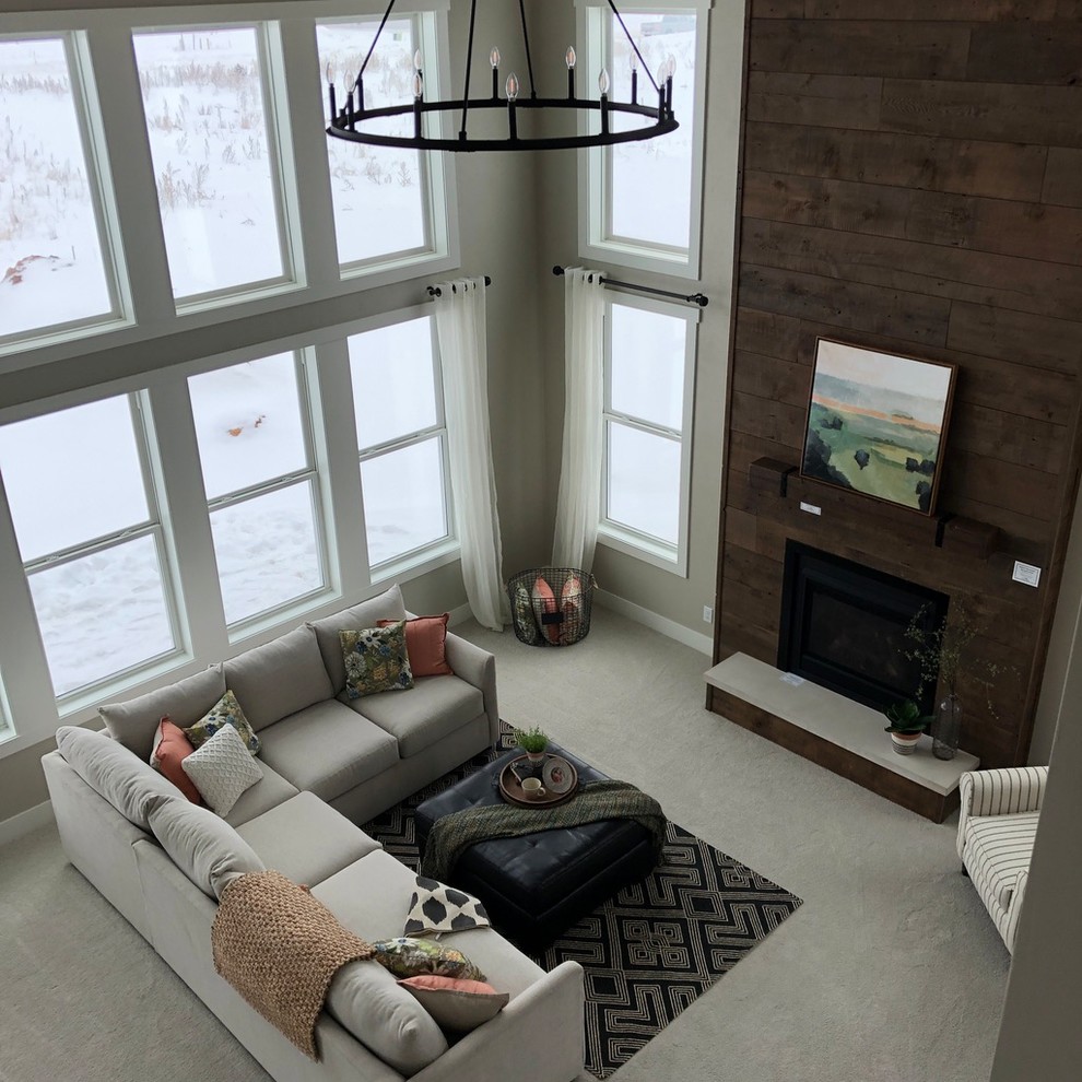 Inspiration for a large country open concept family room in Other with grey walls, carpet, a standard fireplace, a wood fireplace surround and beige floor.