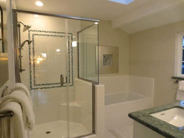 This is an example of a mid-sized contemporary master bathroom in Sacramento with shaker cabinets, white cabinets, an alcove tub, a corner shower, white tile, porcelain tile, beige walls, an undermount sink, granite benchtops, a hinged shower door and green benchtops.