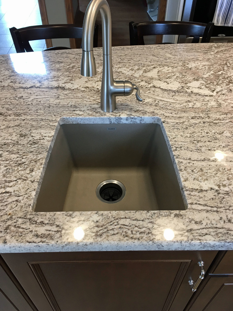 Eat-in kitchen - large transitional l-shaped vinyl floor and beige floor eat-in kitchen idea with a double-bowl sink, recessed-panel cabinets, white cabinets, granite countertops, brown backsplash, ceramic backsplash, stainless steel appliances and an island