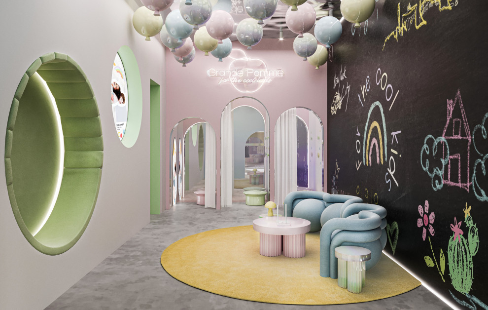 This is an example of a medium sized contemporary gender neutral children’s room in New York with multi-coloured walls, concrete flooring, grey floors and a drop ceiling.