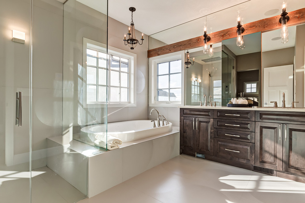 Mid-sized industrial master bathroom in Calgary with raised-panel cabinets, dark wood cabinets, an alcove tub, a curbless shower, beige tile, porcelain tile, beige walls, porcelain floors, an undermount sink and solid surface benchtops.
