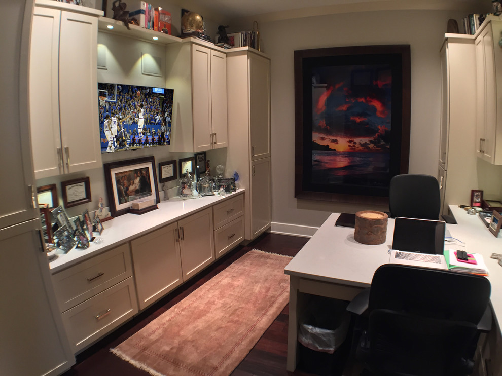 Photo of a mid-sized contemporary study room in Chicago with beige walls, dark hardwood floors and a built-in desk.