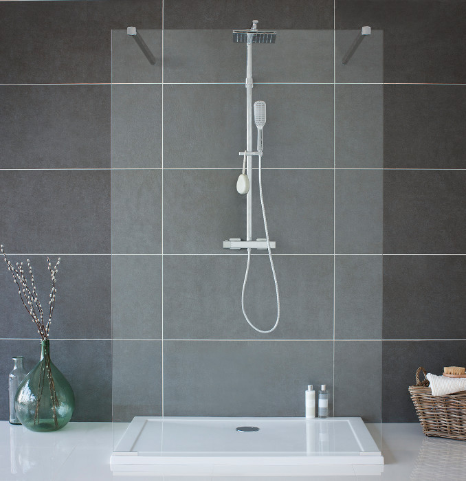 Inspiration for a mid-sized contemporary kids bathroom in Cambridgeshire with flat-panel cabinets, white cabinets, a drop-in tub, a curbless shower, a one-piece toilet, gray tile, porcelain tile, grey walls, marble floors and a pedestal sink.