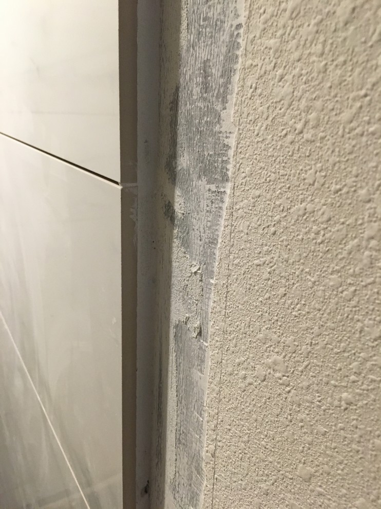 Advice needed! How to address transition from tile to drywall.