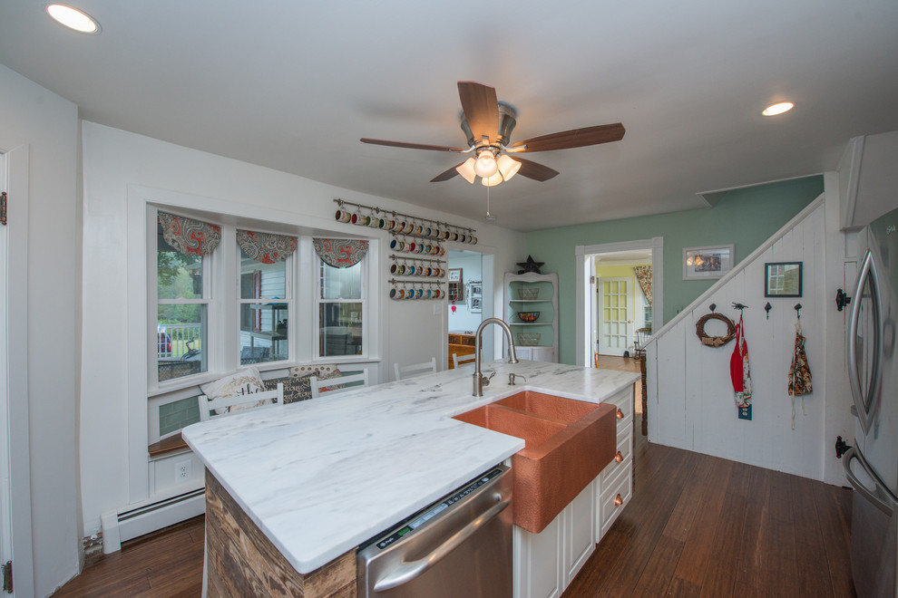 Mid-sized eclectic l-shaped separate kitchen in DC Metro with a farmhouse sink, beaded inset cabinets, white cabinets, quartzite benchtops, blue splashback, glass tile splashback, stainless steel appliances, medium hardwood floors and with island.