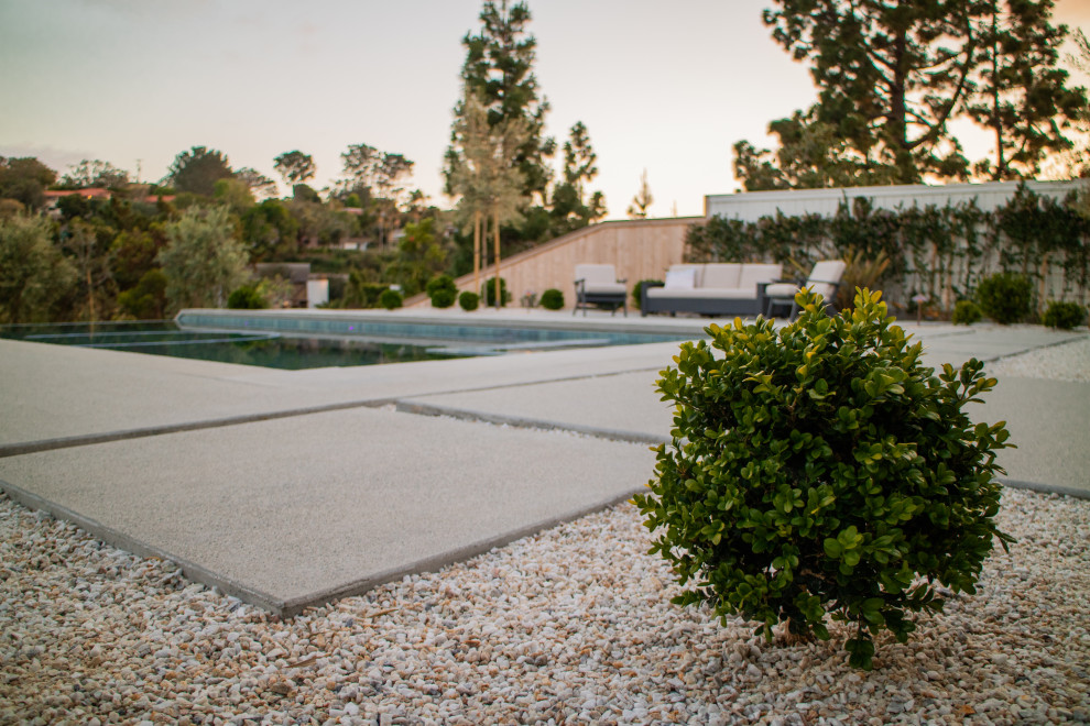 Mid-sized contemporary backyard rectangular pool in San Diego with with a pool and concrete slab.