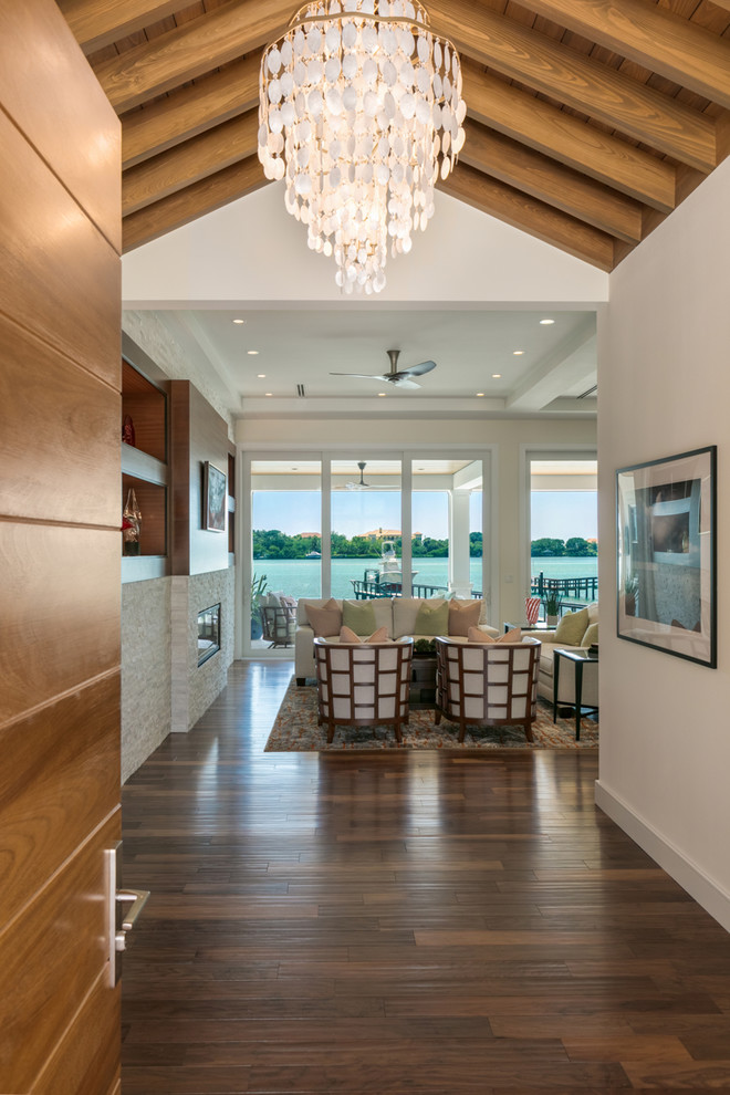 Inspiration for a large transitional foyer in Tampa with white walls, medium hardwood floors, a single front door, a medium wood front door and brown floor.