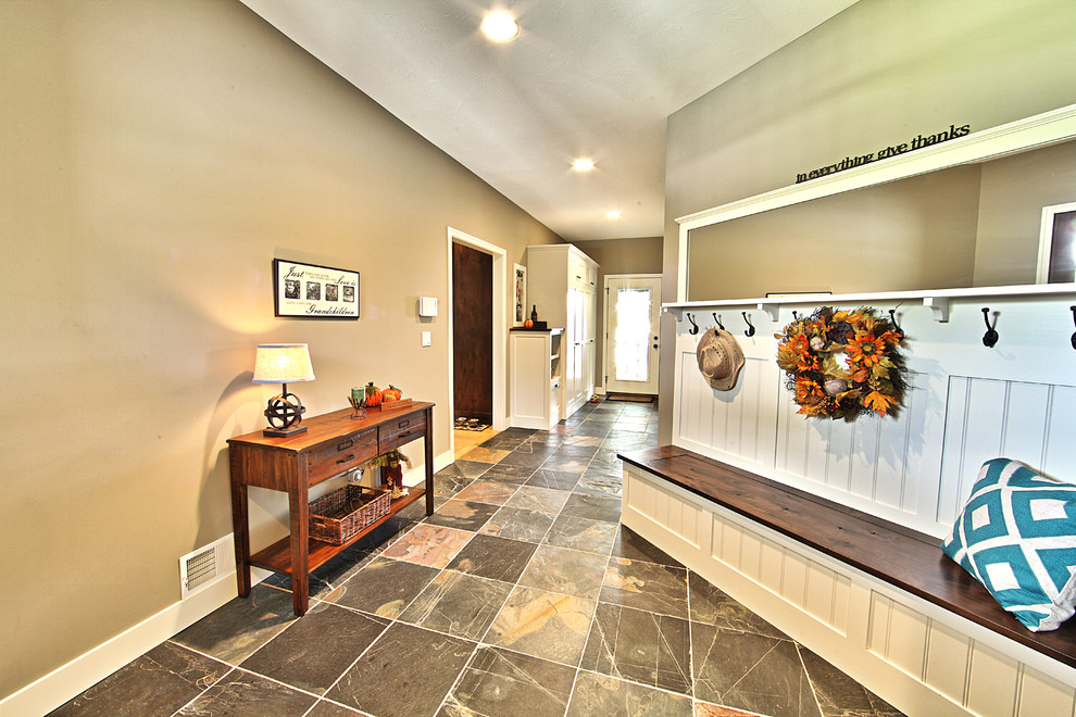 This is an example of a transitional mudroom in Grand Rapids with beige walls and slate floors.