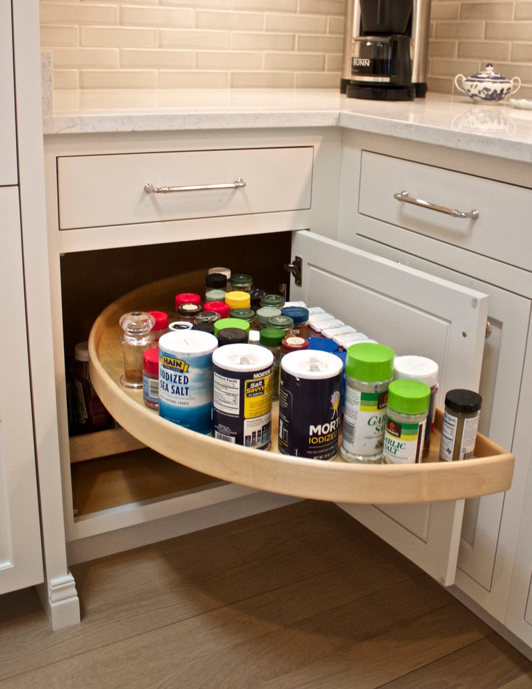 Inspiration for a mid-sized l-shaped dark wood floor eat-in kitchen remodel with flat-panel cabinets, white cabinets, gray backsplash, stainless steel appliances and an island