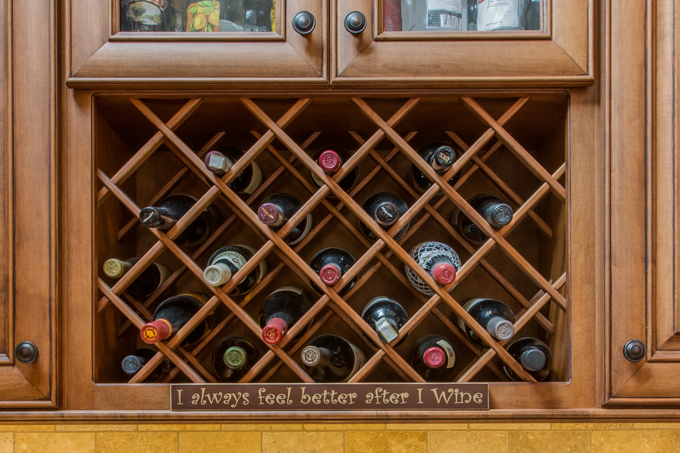 This is an example of a large traditional wine cellar in Boston with brown floor.
