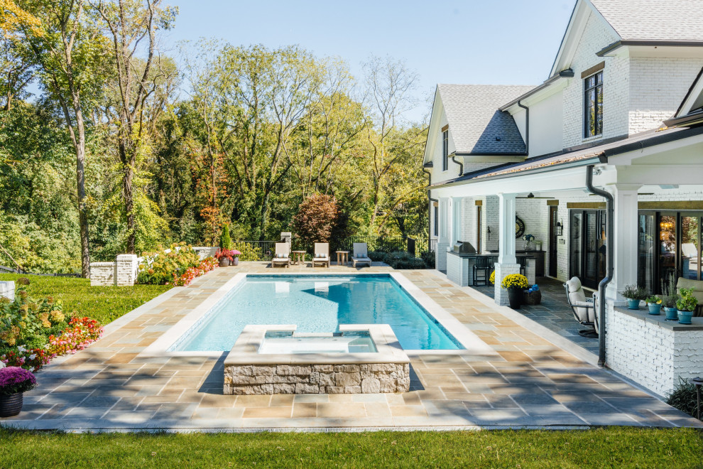 Источник вдохновения для домашнего уюта: прямоугольный бассейн среднего размера на заднем дворе в стиле неоклассика (современная классика) с джакузи и покрытием из каменной брусчатки