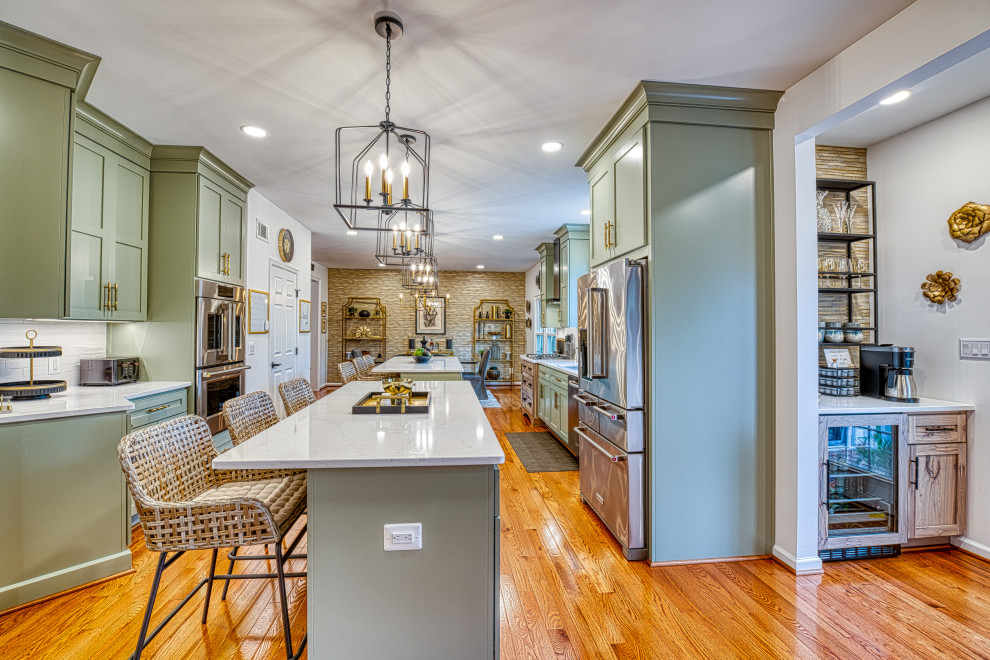Mid-sized mountain style galley light wood floor and brown floor eat-in kitchen photo in DC Metro with an undermount sink, recessed-panel cabinets, green cabinets, quartz countertops, white backsplash, subway tile backsplash, stainless steel appliances, two islands and white countertops
