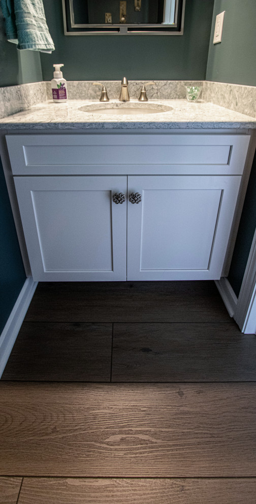 Green Powder Room with White Vanity and Beige and Green Countertop