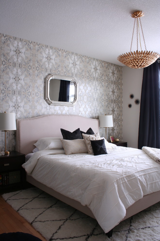 Transitional medium tone wood floor bedroom photo with multicolored walls