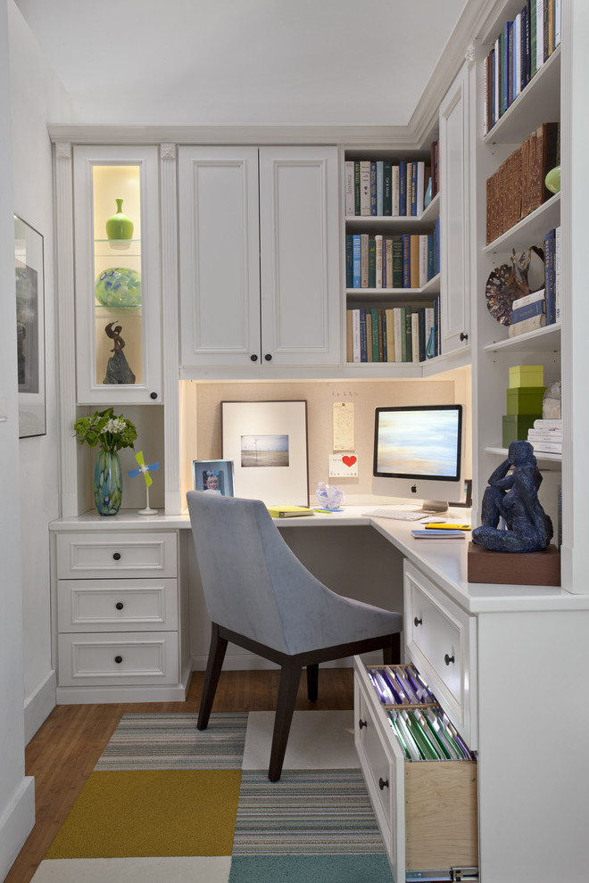 Design ideas for a mid-sized traditional study room in New York with white walls, medium hardwood floors and a built-in desk.