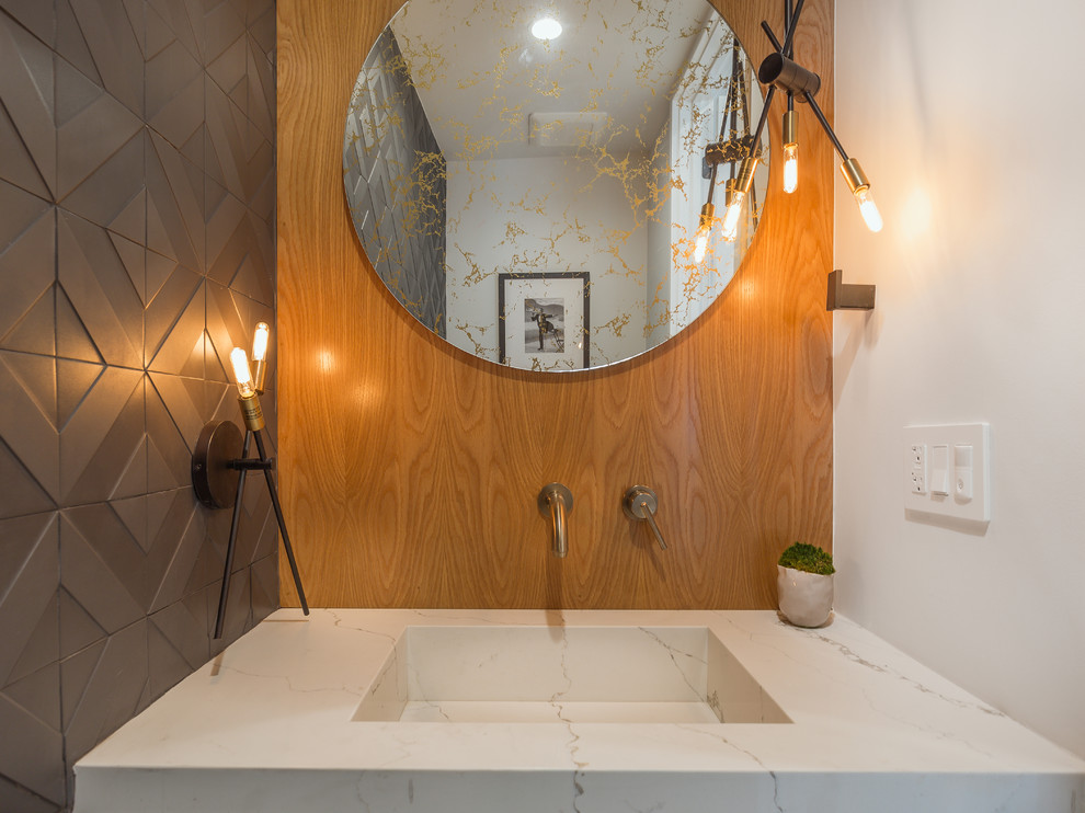 Design ideas for a mid-sized midcentury powder room in Los Angeles with an integrated sink.