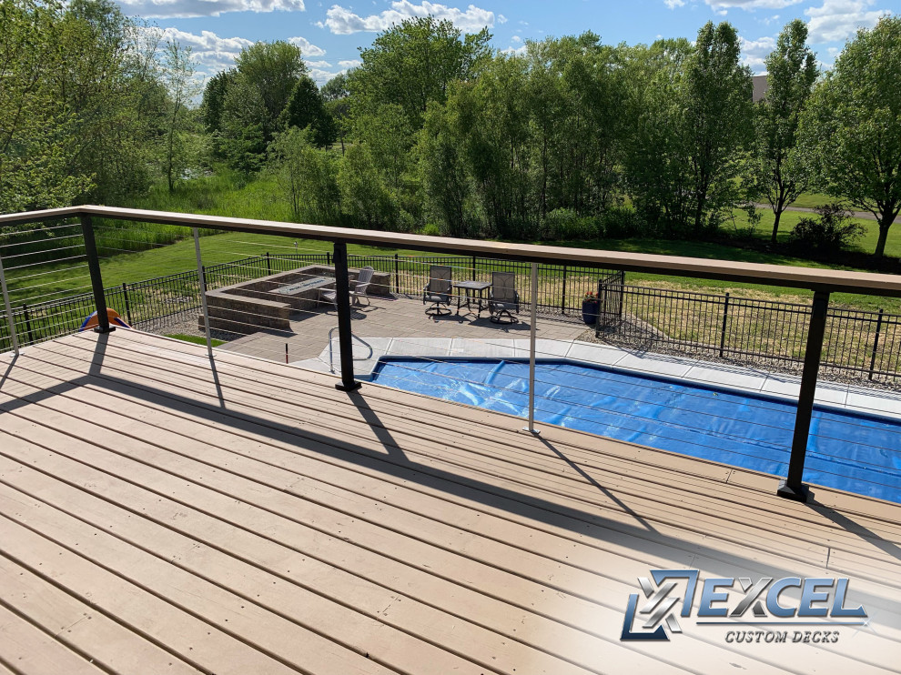 Design ideas for a mediterranean backyard custom-shaped lap pool in Milwaukee with decking.